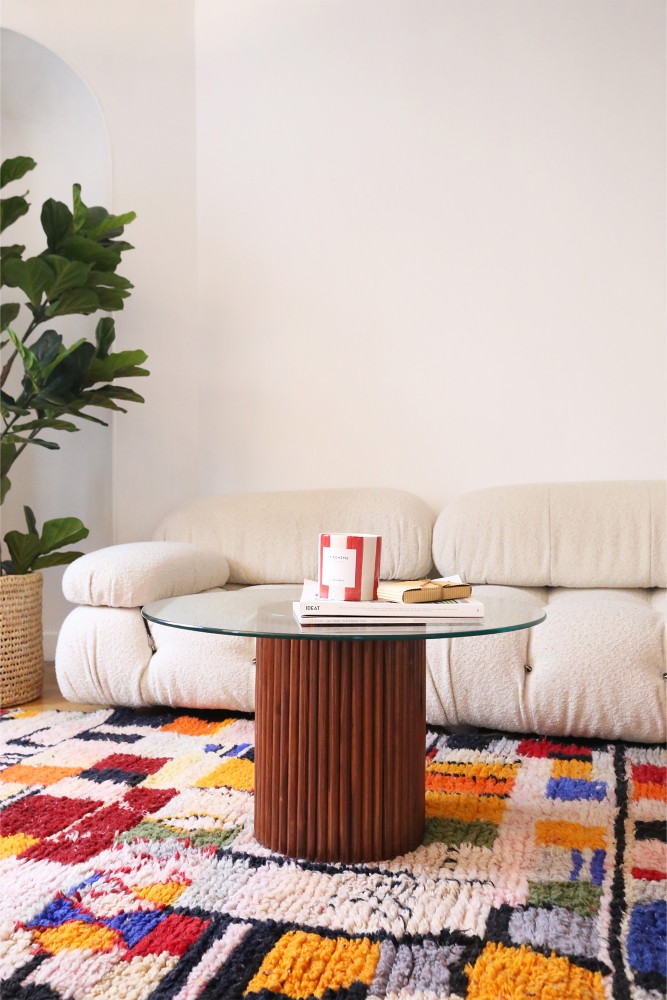 Wooden coffee table with a 70cm glass top and striped leg.