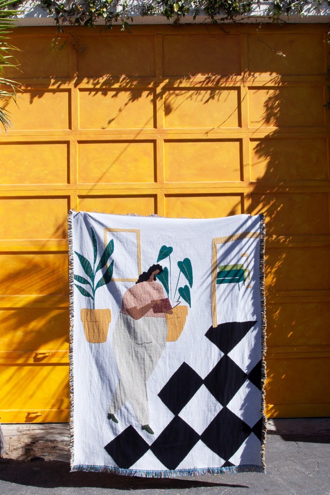 Dekentje gemaakt van gerecycled katoen met zwart, geel en groene patronen in de VS.