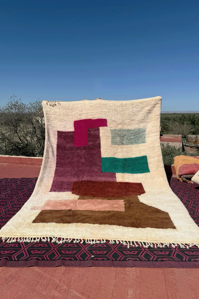 Very large modern white Azilal Berber carpet with splashes of colors in green, brown, pink, and terracotta.