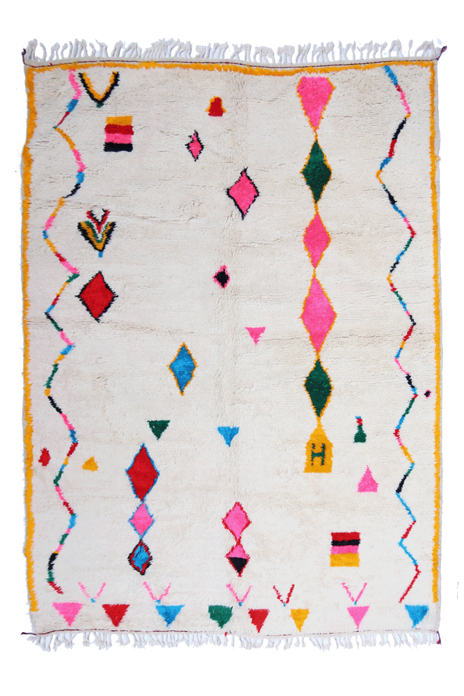 Very large white Azilal Berber rug with diamonds and zigzags in pink, green, blue, and yellow border.